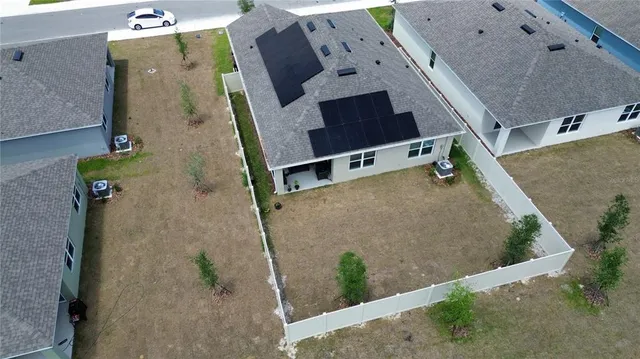 an aerial view of a house with a yard