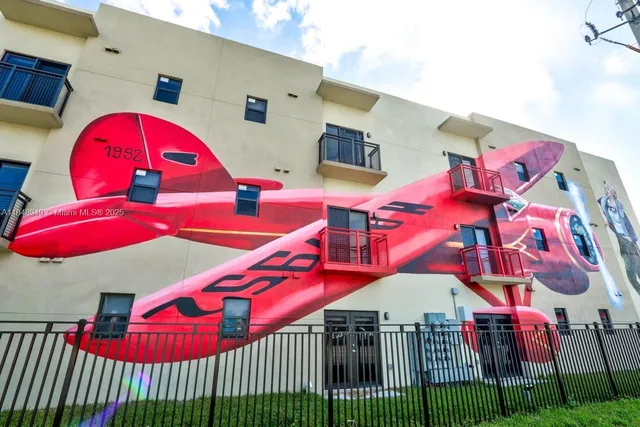 a living room with furniture fireplace and kitchen view