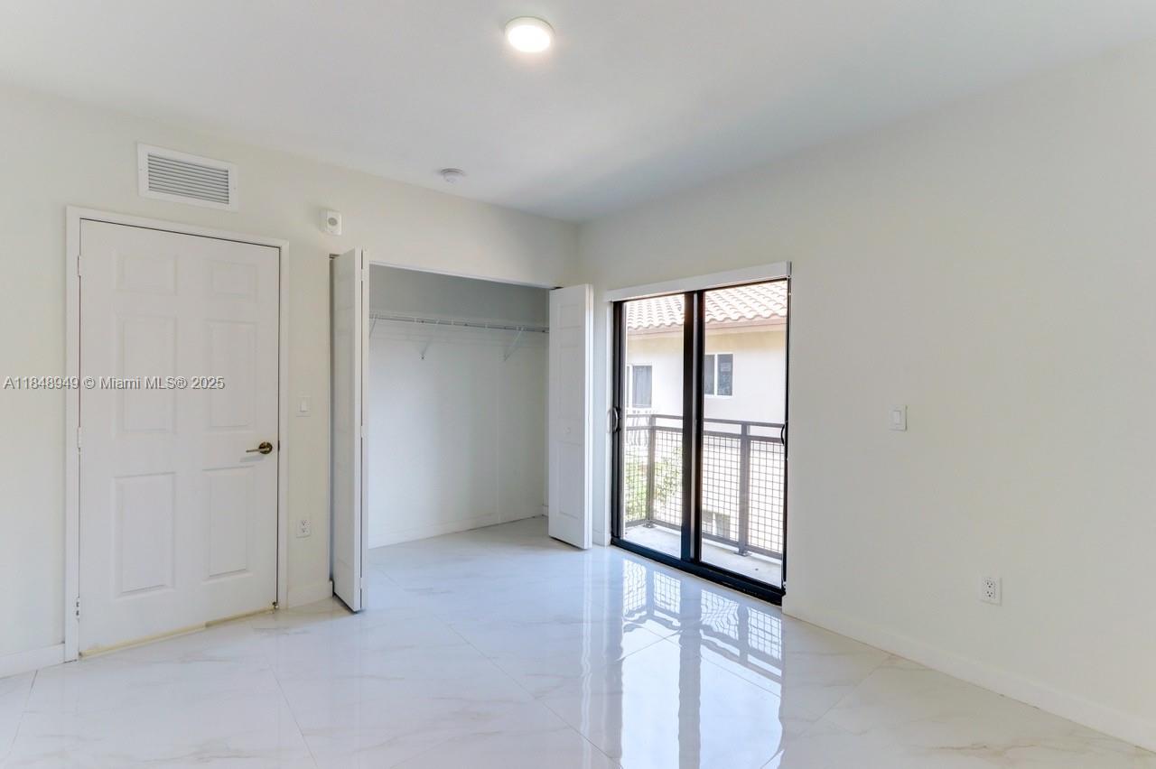 339 West 78th Road, Unit 203 Hialeah, FL 33014 - Photo 16 of 23 an empty room with windows and closet