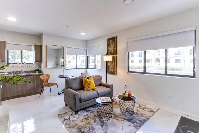 a kitchen with granite countertop stainless steel appliances a refrigerator a stove a dining table and chairs