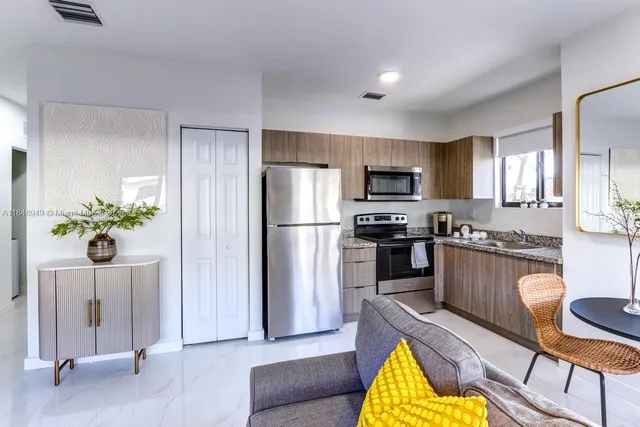 a living room with furniture a flat screen tv and a window