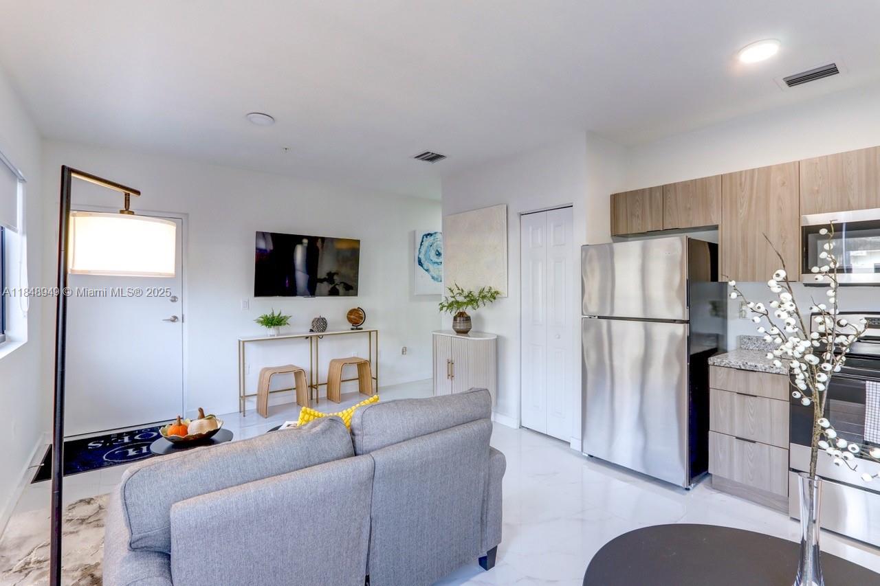 339 West 78th Road, Unit 203 Hialeah, FL 33014 - Photo 8 of 23 a living room with furniture and a flat screen tv