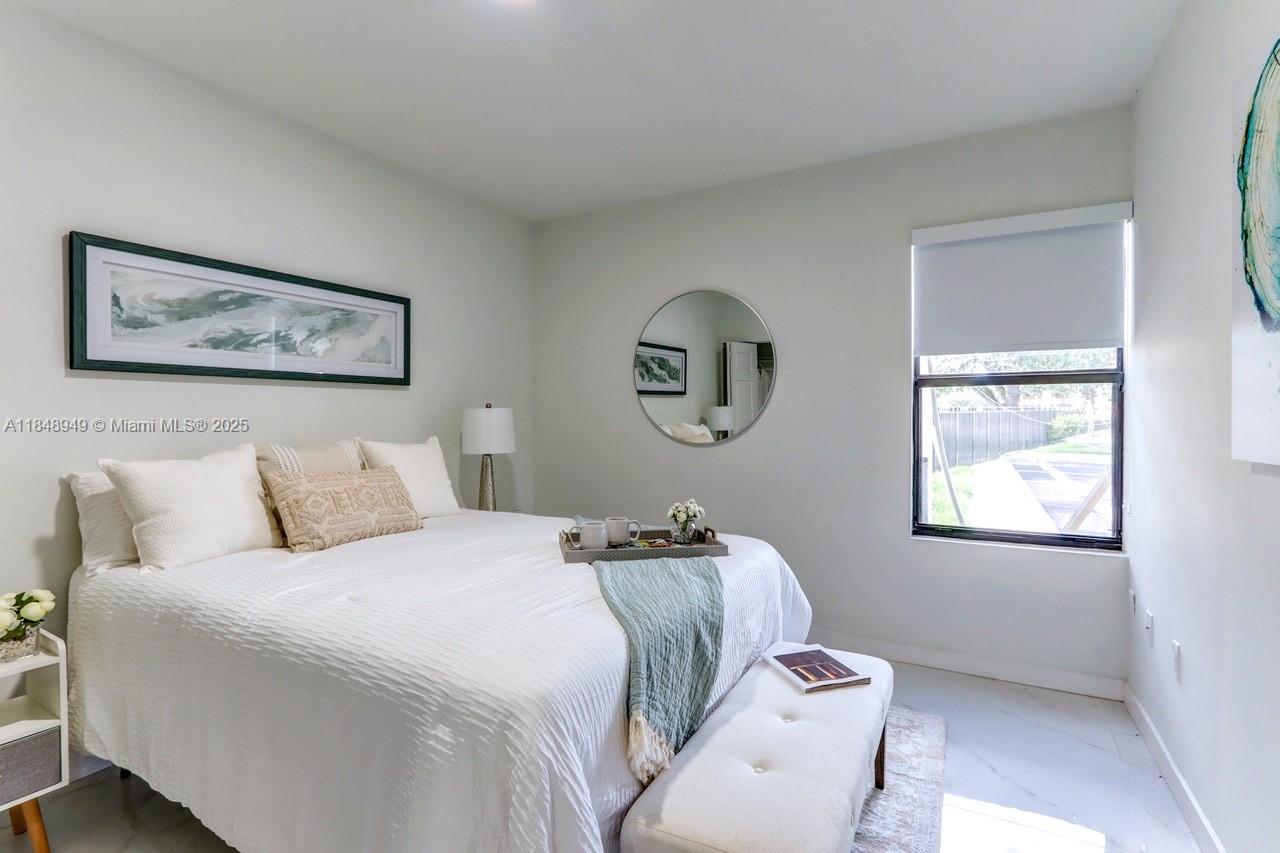 339 West 78th Road, Unit 203 Hialeah, FL 33014 - Photo 9 of 23 a bedroom with a bed and a painting on the wall