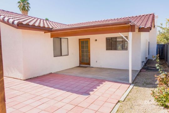 642 Regency Court Ridgecrest, CA 93555 - Photo 30 of 33 a view of a blue house with a yard