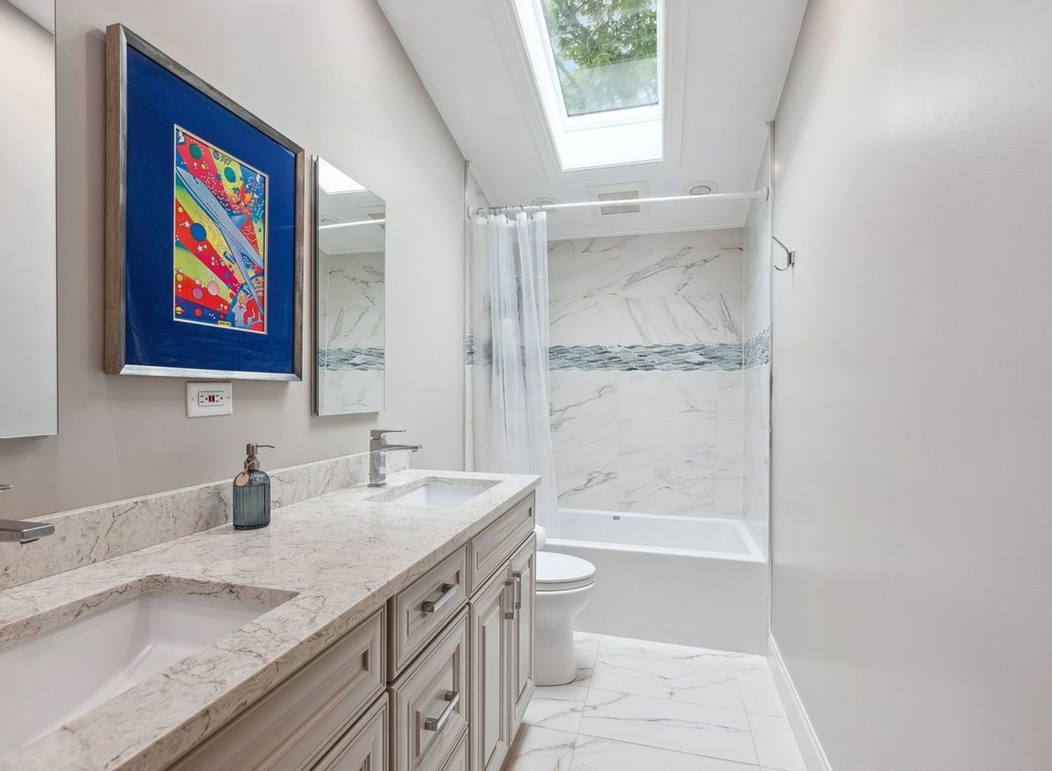 694 Buena Road Lake Forest, IL 60045 - Photo 24 of 39 a bathroom with a granite countertop sink a mirror a bathtub and shower