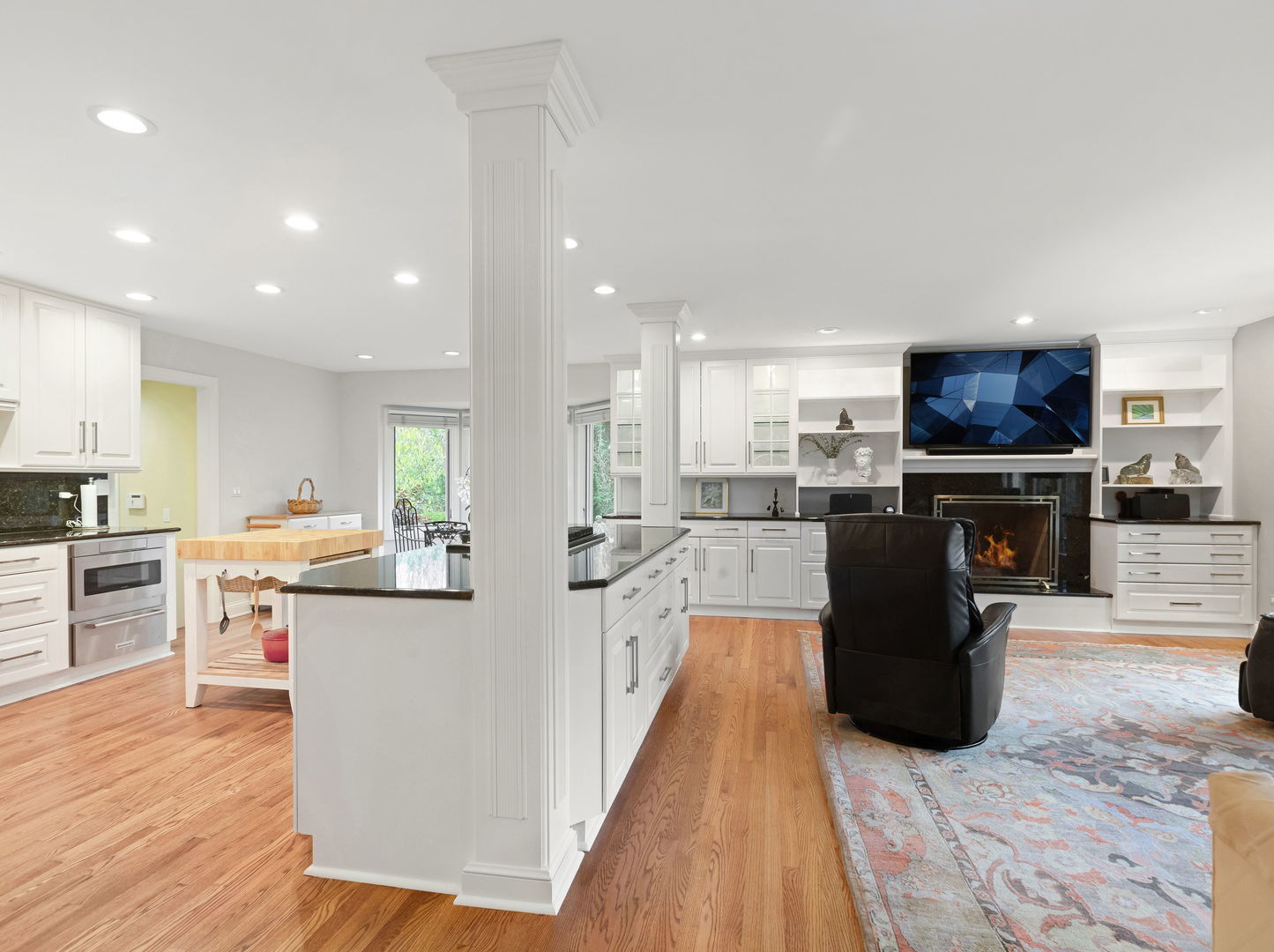 694 Buena Road Lake Forest, IL 60045 - Photo 6 of 39 a kitchen with stainless steel appliances kitchen island granite countertop a stove top oven a sink a counter top space and cabinets