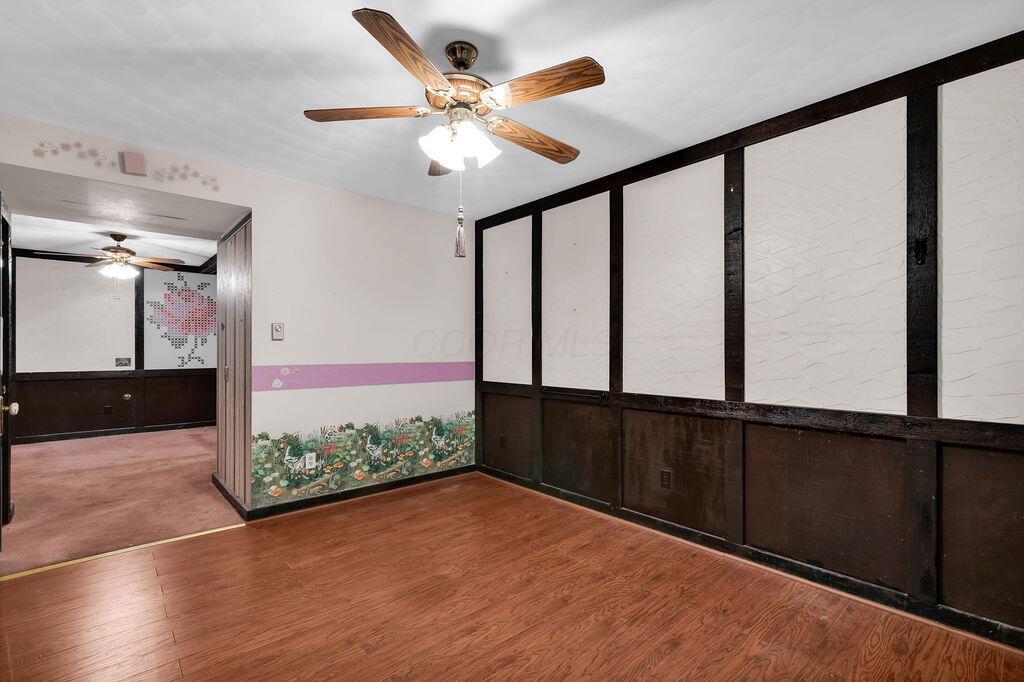 4409 Newton Road Northeast Newark, OH 43055 - Photo 50 of 87 • Neutral vinyl flooring • Ivory painted walls • Lighted ceiling fan • Faux fireplace • Lighted closet with bi-fold doors