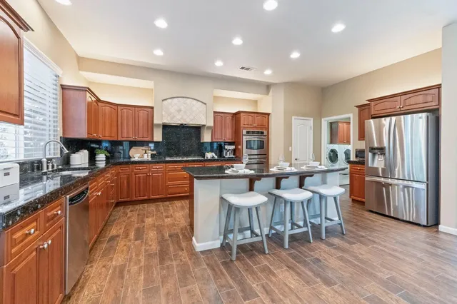 a large kitchen with lots of counter space and stainless steel appliances