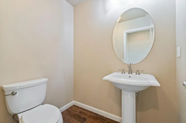 a bathroom with a sink a mirror and toilet