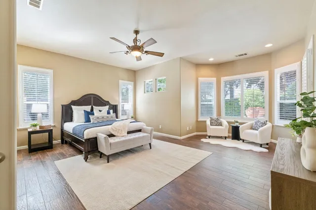 a bedroom with a large bed and a large window
