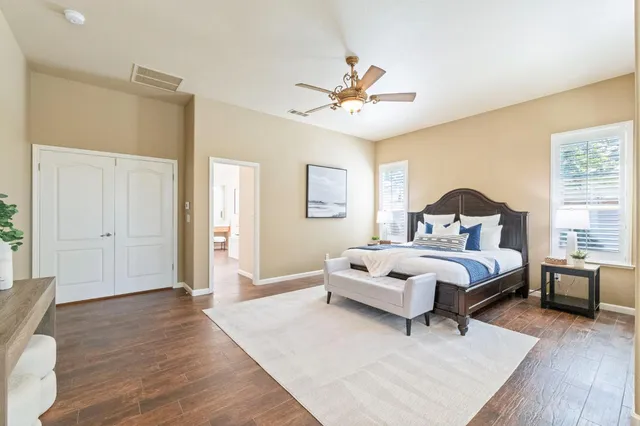 a spacious bedroom with a bed and a window