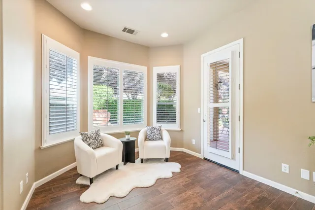 a living room with furniture and large windows