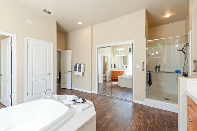 a spacious bathroom with a shower and a sink