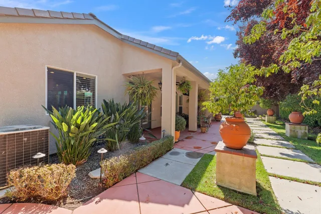a view of a house with backyard and sitting area