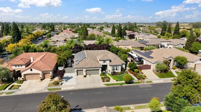 an aerial view of residential houses with outdoor space and swimming pool