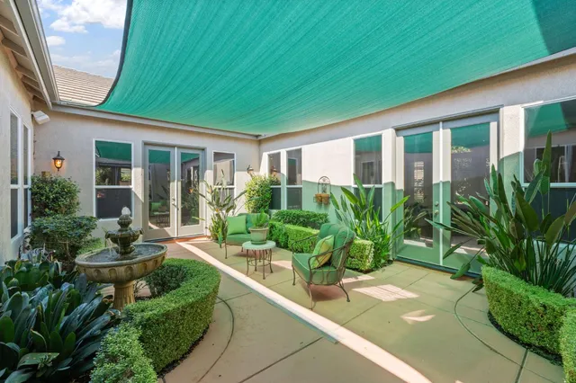 a front view of a house with porch and outdoor seating