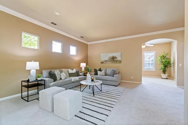 a living room with furniture and a lamp