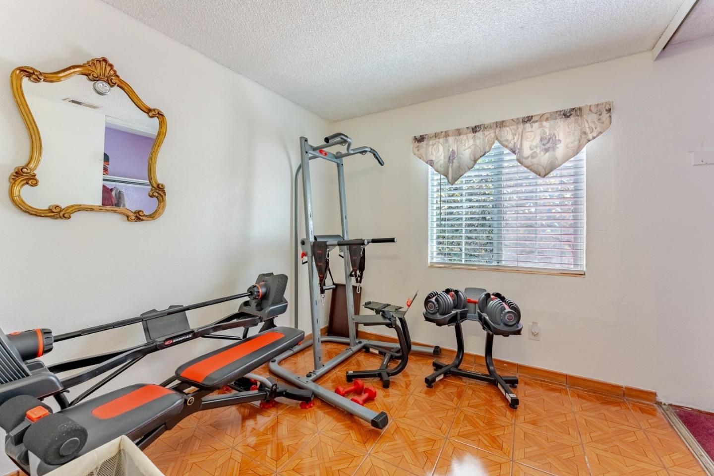 2776 Cramer Circle San Jose, CA 95111 - Photo 15 of 22 a room with gym equipment and windows