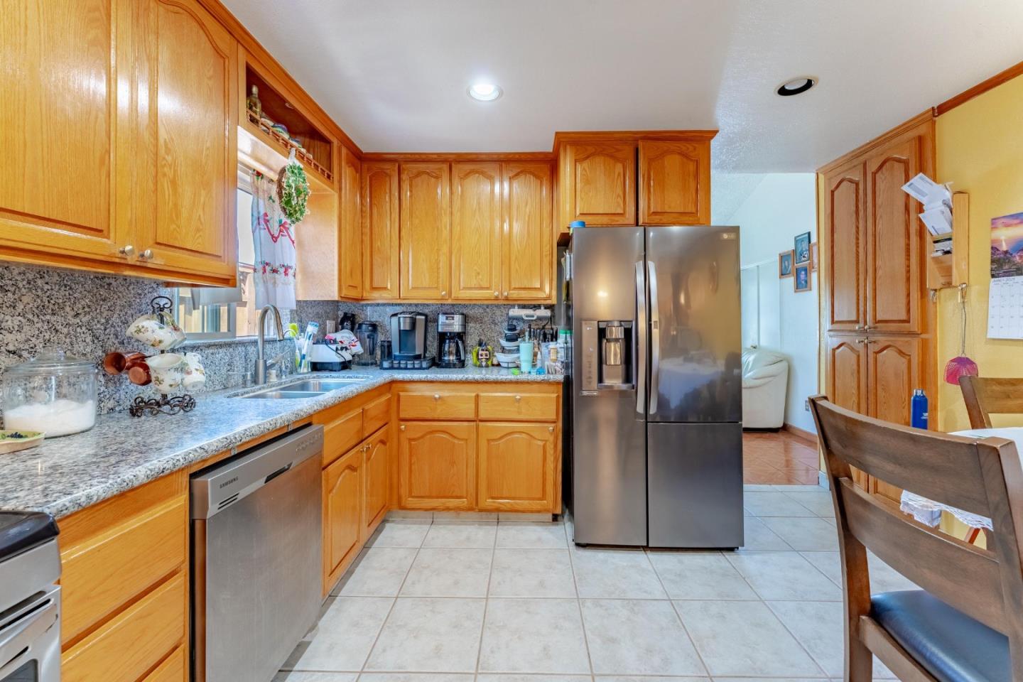 2776 Cramer Circle San Jose, CA 95111 - Photo 7 of 22 a kitchen with stainless steel appliances granite countertop a refrigerator a sink a stove a washer dryer and a refrigerator