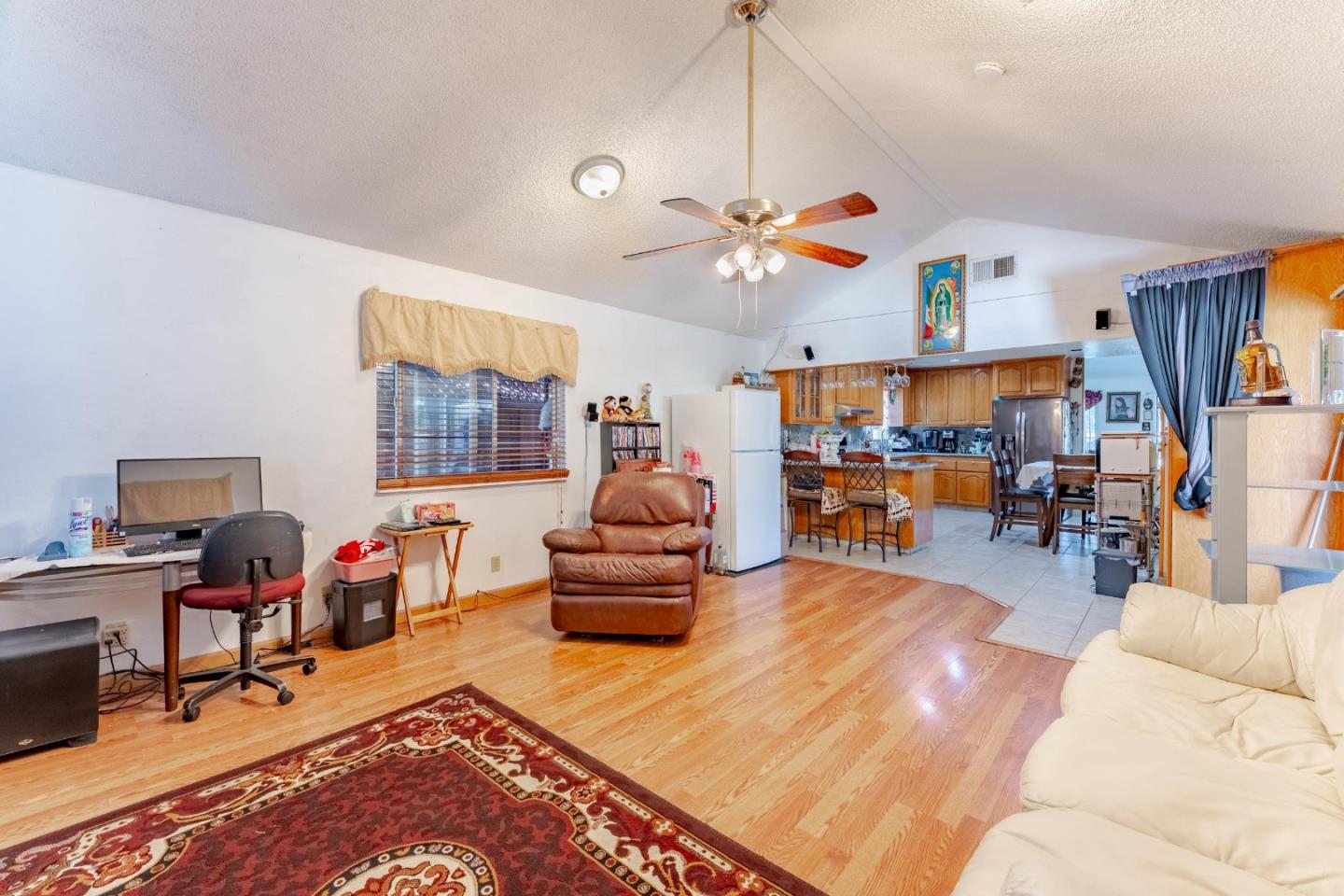 2776 Cramer Circle San Jose, CA 95111 - Photo 10 of 22 a living room with furniture a chandelier and a floor to ceiling window