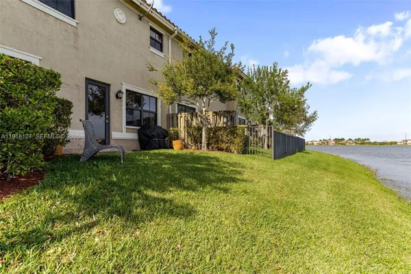 a view of a house with a yard and sitting area