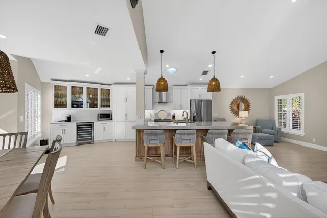 a living room with furniture a fireplace and kitchen view