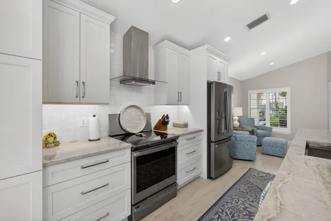 a kitchen with stainless steel appliances granite countertop a sink stove and refrigerator