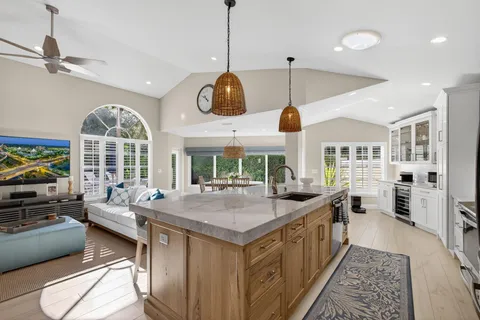 a kitchen with stainless steel appliances granite countertop a stove and a large window