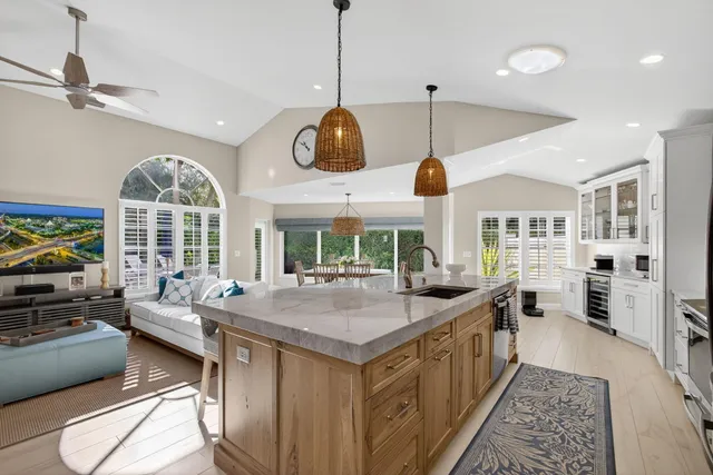 a kitchen with stainless steel appliances granite countertop a stove and a large window