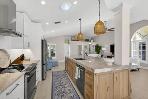 a kitchen with sink stove and cabinets