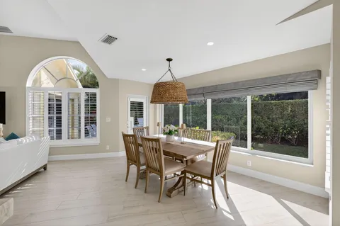 a dining room with furniture window and outside view