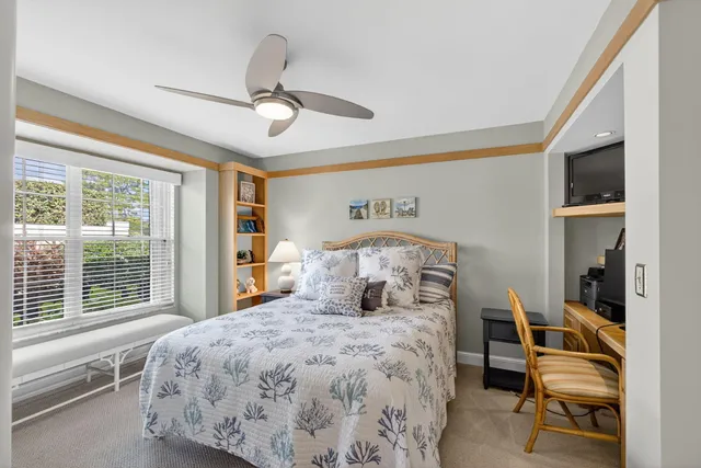 a bedroom with a large bed and a large window