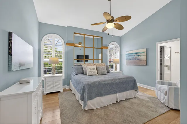 a bedroom with a bed and a chandelier