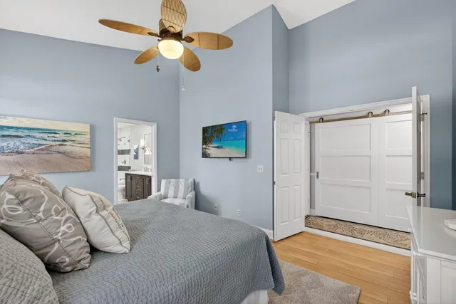 a bedroom with a bed and a chandelier