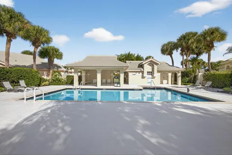 a view of house with a swimming pool and a chairs