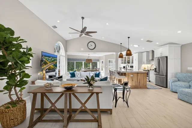 a living room with lots of furniture and a large window