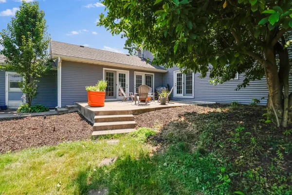 a wooden bench sitting in front of a house