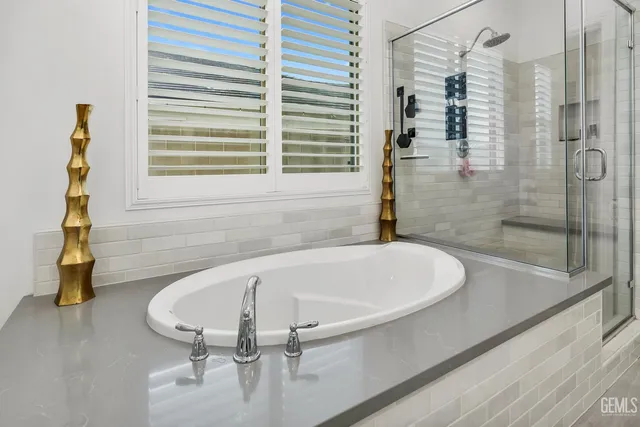 a kitchen with stainless steel appliances granite countertop a kitchen island hardwood floor and a sink