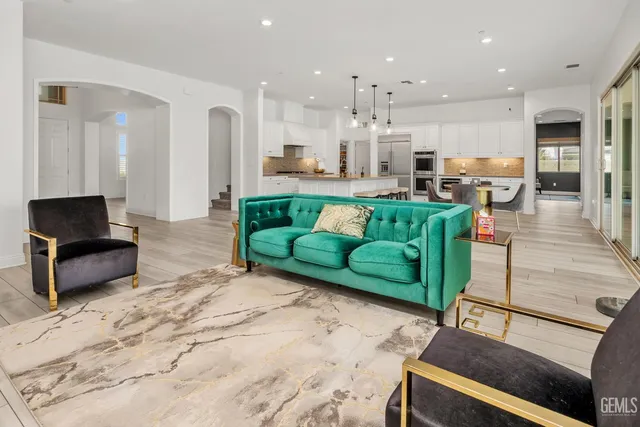 a large kitchen with stainless steel appliances kitchen island granite countertop a sink and cabinets