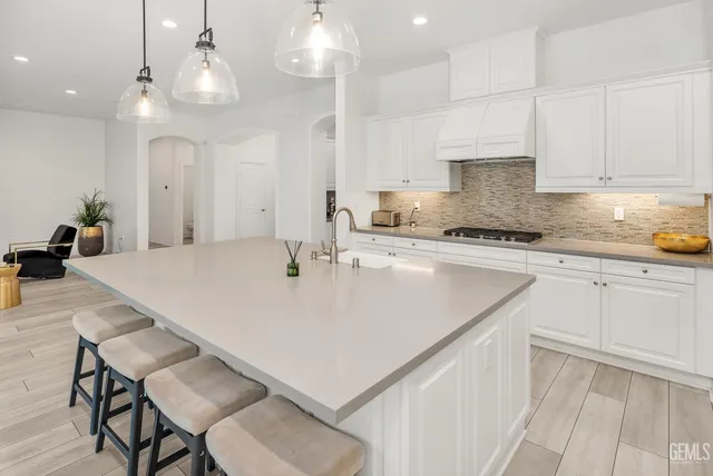a living room with furniture and a view of kitchen