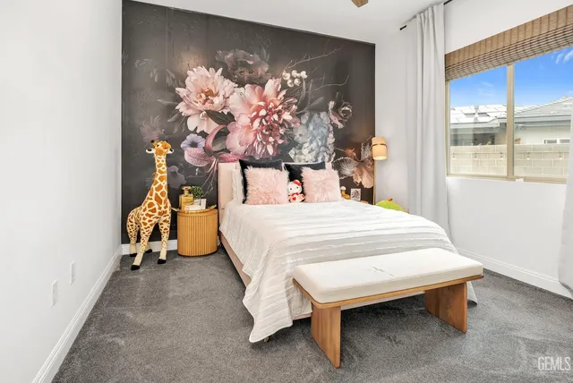 a view of swimming pool with a yard and large trees