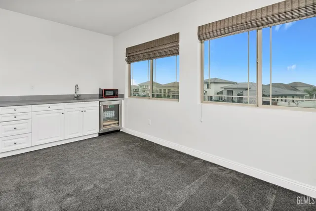 a view of a swimming pool with a lawn chairs under an umbrella