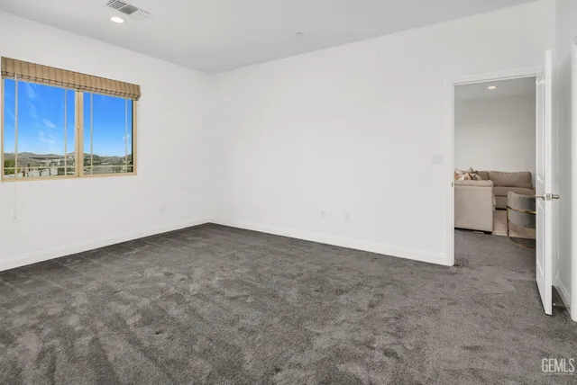 an aerial view of residential houses with swimming pool and ocean view