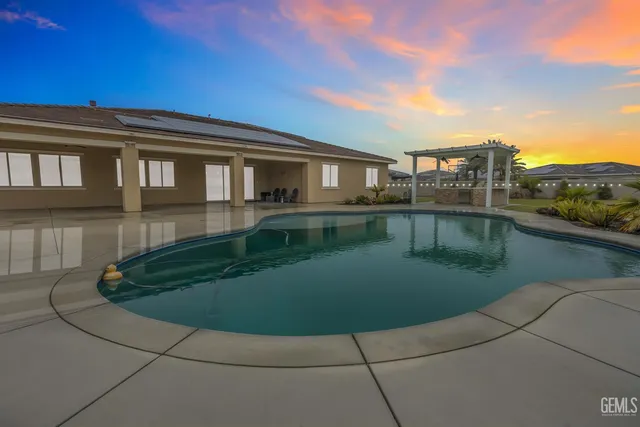 an aerial view of a house with a swimming pool