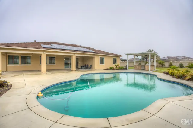 an aerial view of a house with a swimming pool