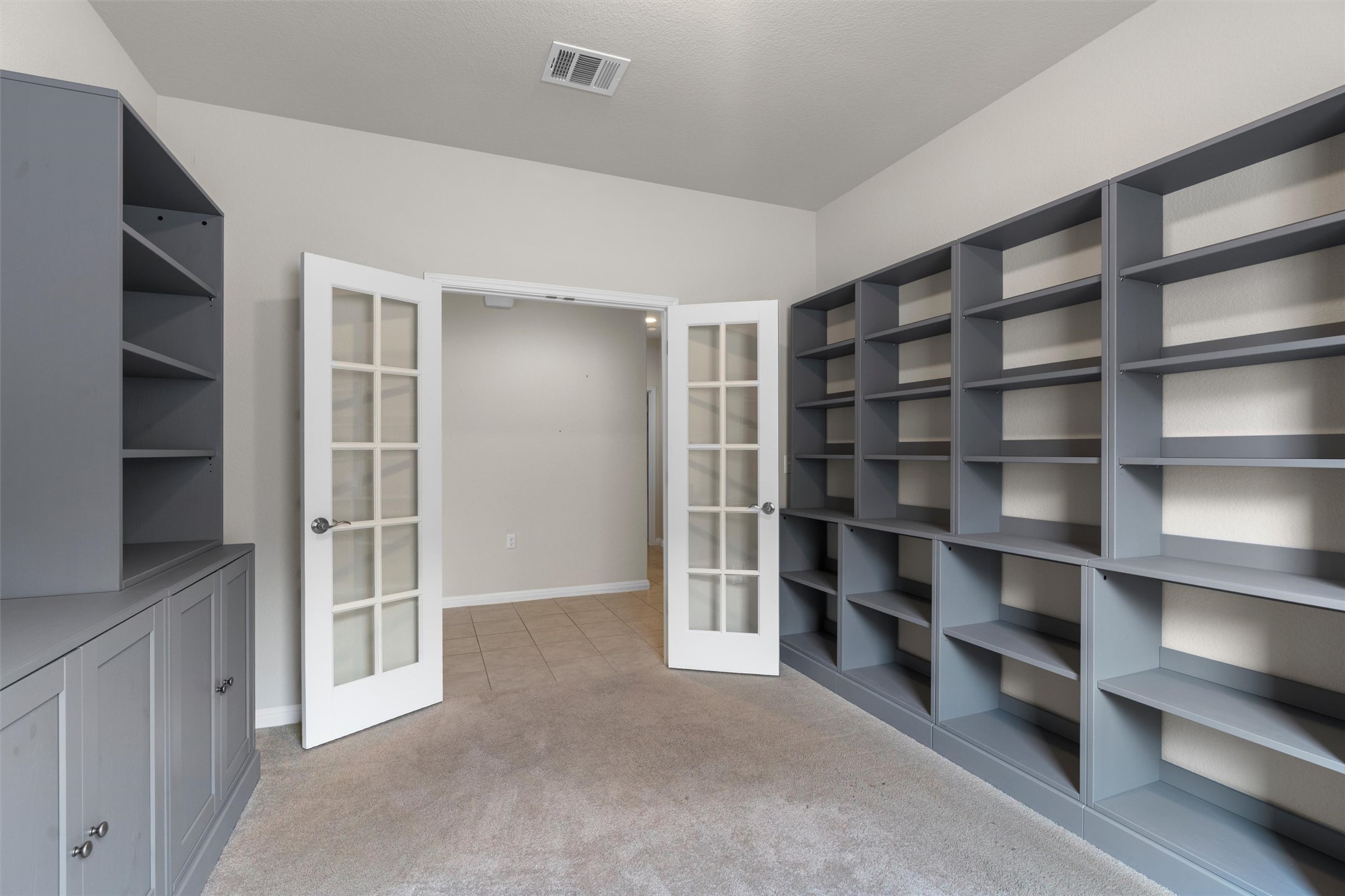 108 Calhoun Lane Georgetown, TX 78633 - Photo 5 of 32 a view of an empty room with empty shelves