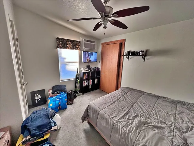 a bedroom with bed and a chandelier