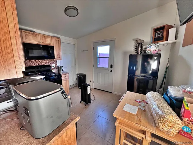 a kitchen with a sink stove top oven and microwave