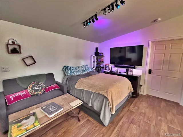 a view of a workspace with furniture and wooden floor