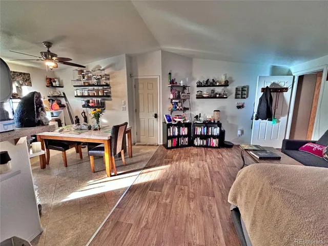 a view of a dining room with furniture and a flat screen tv
